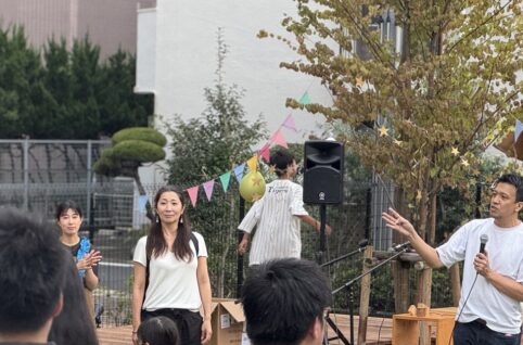 1周年感謝祭のステージでマイクを持って話す様子